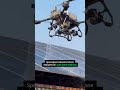 The DJI Agras T100 is a high-capacity industrial drone designed to clean large solar arrays