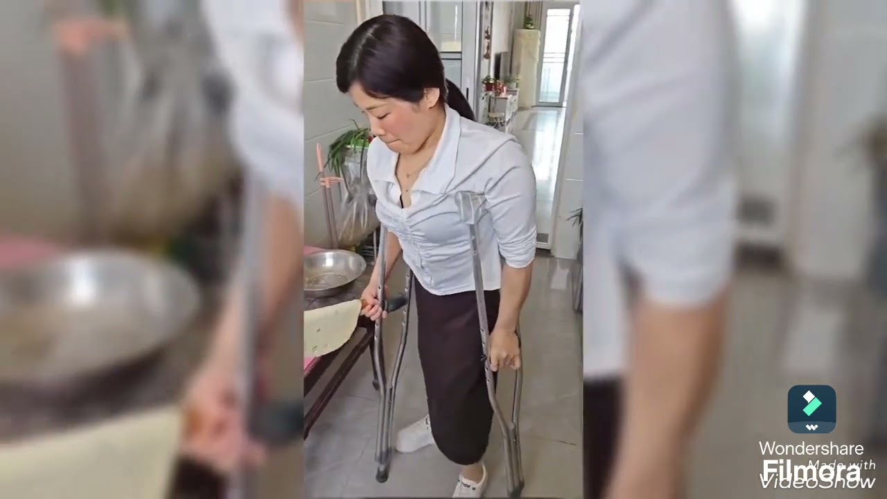The beautiful woman with polio walks confidently on crutches 
