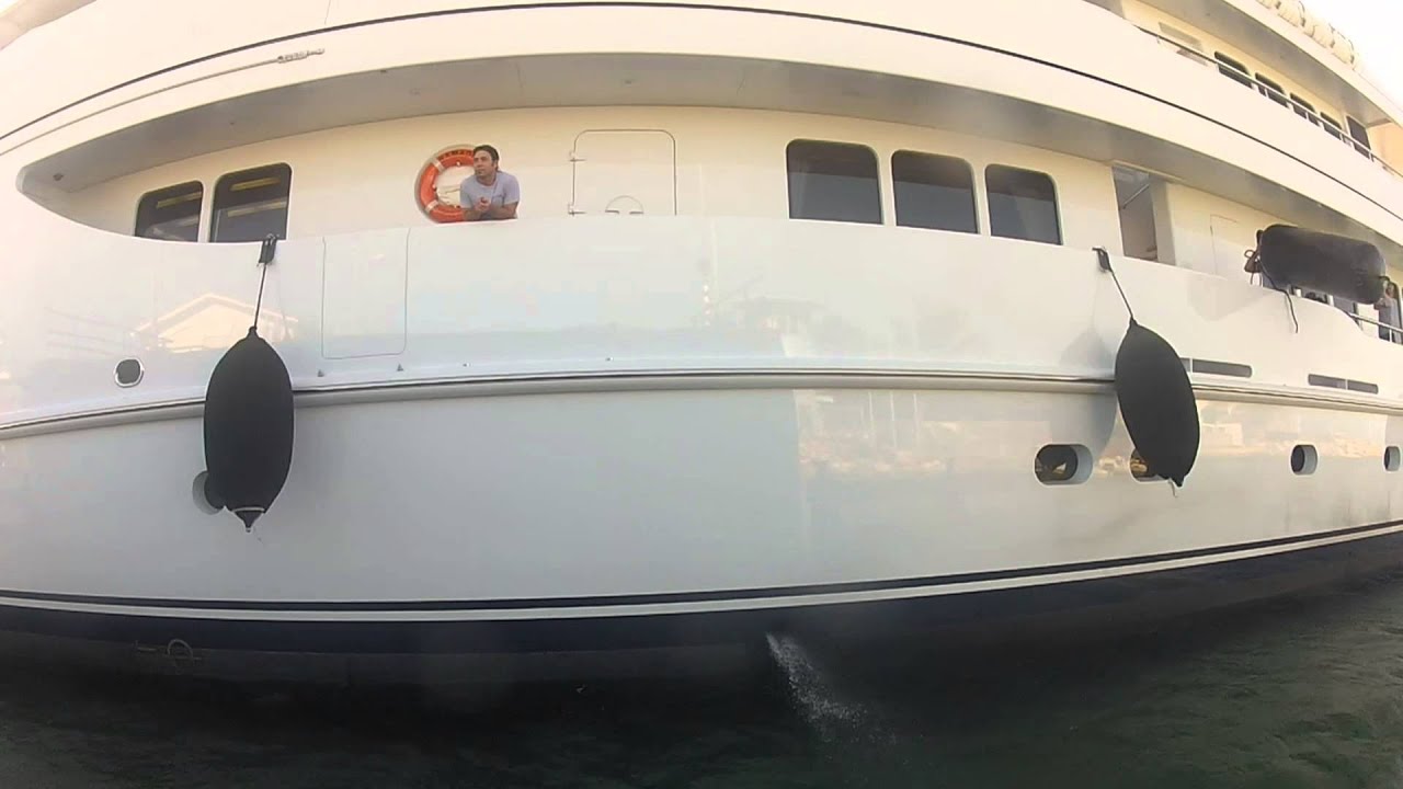Three large yachts pass under the St Martin Bridge