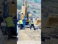 Striking the Pin: How Workers Secure an Excavator Attachment