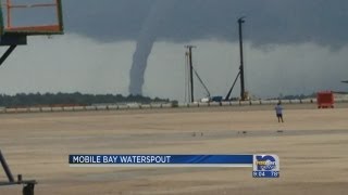 Locals watch water spout form over Mobile Bay