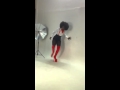 Amara behind the scene at photo shoot  streching with thight hight red boots