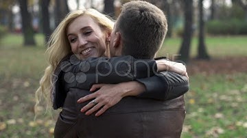 Happy couple hugging in the park, slow motion, shot at 240fps HD. Stock Footage