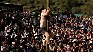 American participating in the greased pole climbing competition, Hornbill Festival