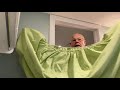 Greg folds a fitted sheet