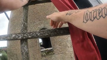 Dutch millers climbs a windmill wick