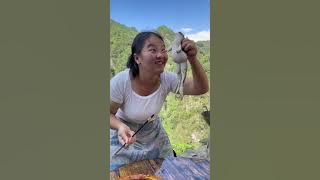 Asian girl eats a raw frog. Chinese food