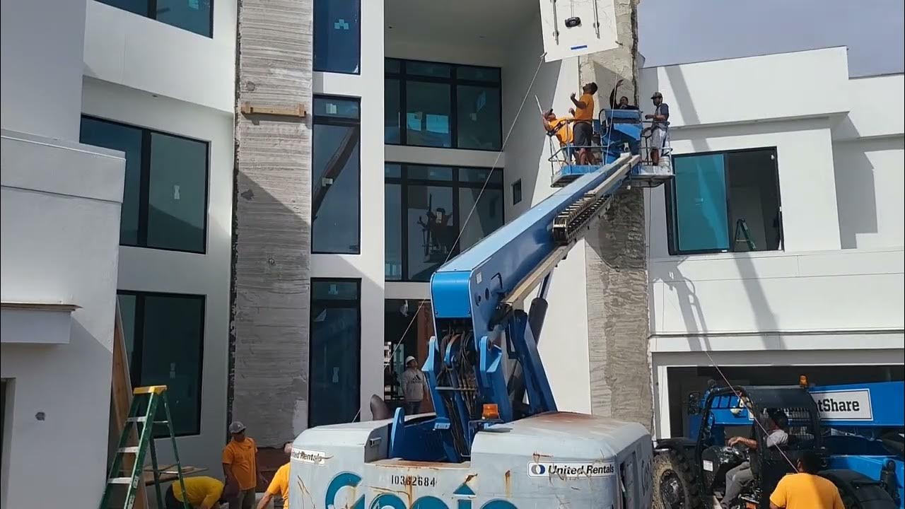 Crane performs more lifts of marble slab to front of house sides! YouTube