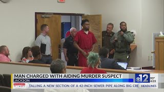 Man charged with aiding Jackson murder suspect