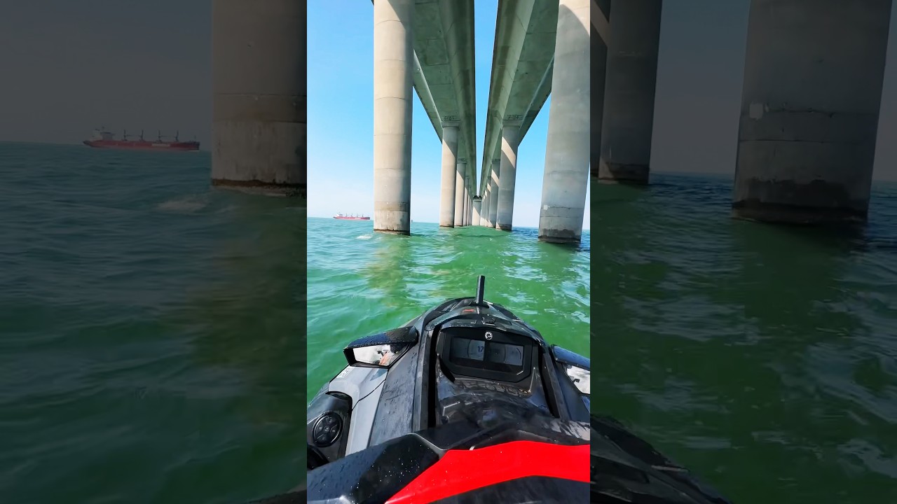 Insane riding Jet Ski under Skyway Bridge with massive ship