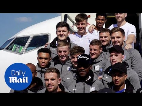 Smiley faces as England World Cup team land back into the UK - Daily Mail