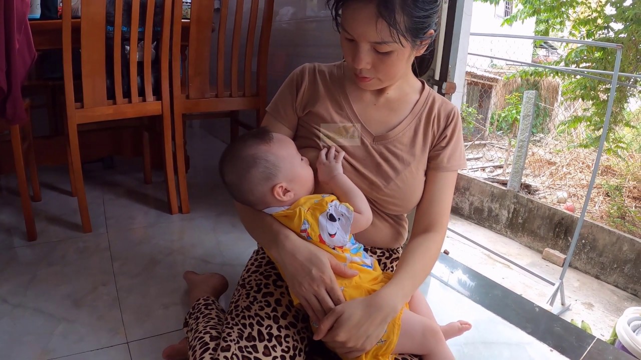 Mom Thuy is breastfeeding at home as daily routine for baby while she is  doing cooking... - YouTube