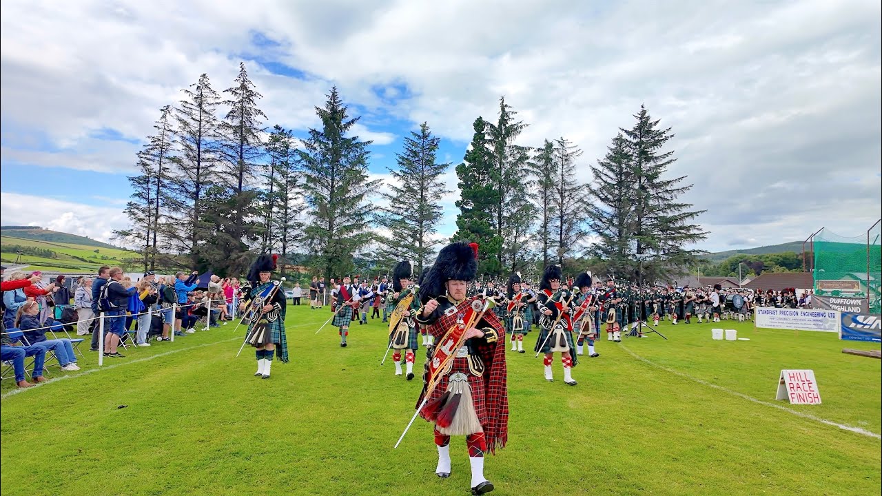 Drum Major leads the massed Pipes and Drums march in during 2024 Dufftown Highland Games in Scotland