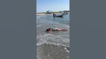 Girl Face Plants Into Sand During Wake Surfing Trick at Beach - 1434068
