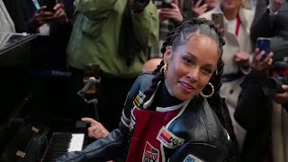 Alicia Keys hits the keys on famous piano in a London station