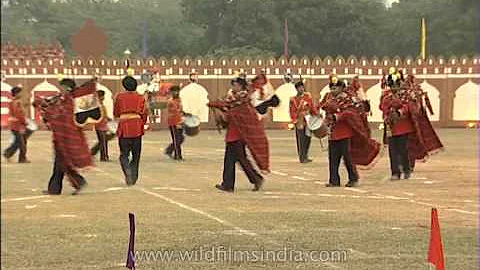 Army unit with music instrument performing a march past