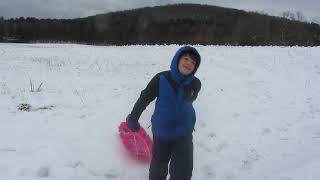Ethan sledding on the hill