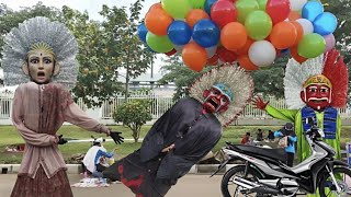 DRAMA OF ONDEL-ONDEL FLYING UNDER A BALLOON, UNABLE TO CRY