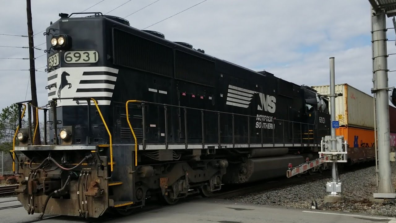 A Norfolk Southern locomotive leads backwards on an all double stack ...