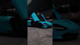 Stunning blue supercar with iconic dihedral doors parked under a modern structure. #Supercar