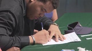 Football player born with hearing impairment signs with college