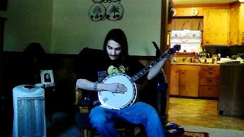 Travis playing a 4 string banjo