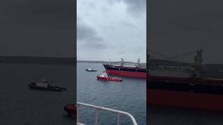 Tug Boats Safeguard A Big Ship To Safely Leave From Port