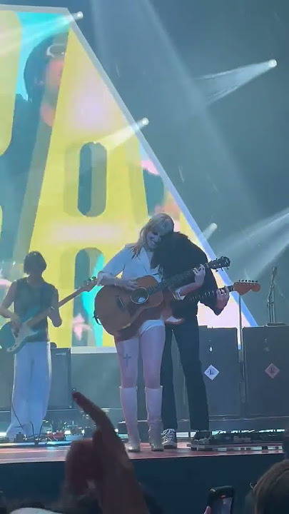 Taylor York leans over Hayley Williams