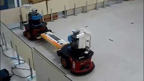 Two robots are carrying an object over forks in line formation - RealWorld Application (HQ)