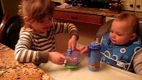 Angelina feeds her brother Alex