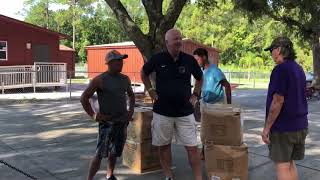 Marjorie's Hope School Superintendent  volunteering for backpacks 2018