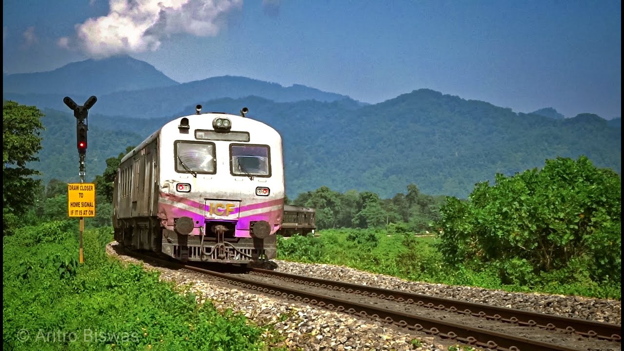 DEMU passenger train passing a greenery surrounded huge curve || Northeast Frontier Railway