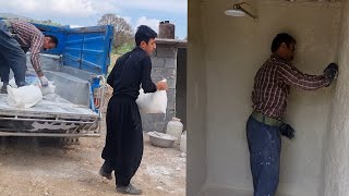 Plastering the bathroom walls by Amir and baking local bread by Elham and his mother