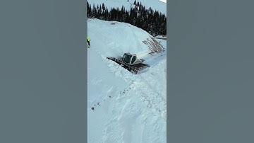 Mountain Top Snow Drift get Plowed by Snowcat