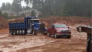 my ford f150 in the mud pulling out a stuck dump truck