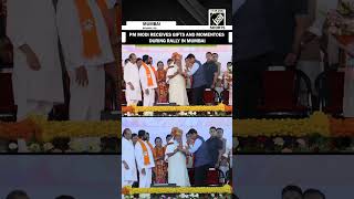 PM Modi receives gifts and momentoes during rally in Mumbai