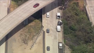 Overturned truck spills bag of cement off of I-805, kills passenger in car below