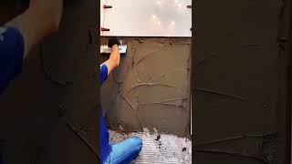 Spreading tile adhesive evenly with notched trowel