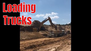 CAT Excavators Loading Trucks