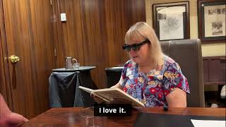 A lady trying book reading demo using EchoVision during ACB