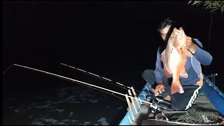 Night fishing in front of the shrimp harvesting pond