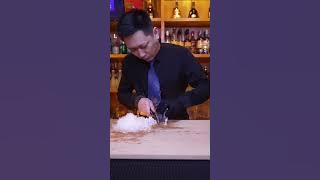 BB Bartender cuts diamond ice with hand cubes to make a cup of mellow and elegant cocktail