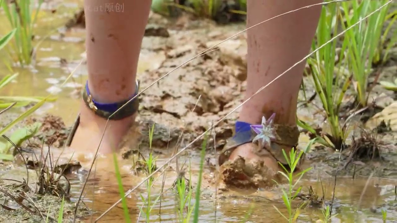 The girl's high heel got stuck in the mud.