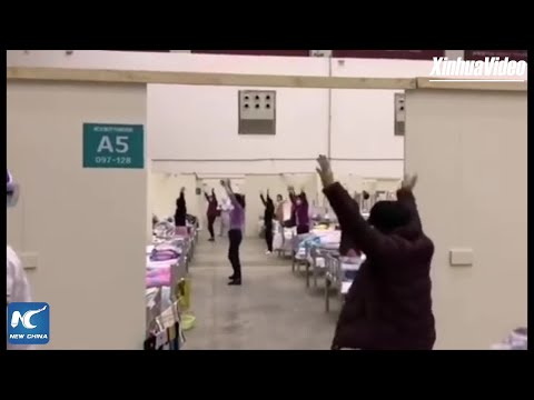 Patients with coronavirus dance at a temporary hospital in Wuhan