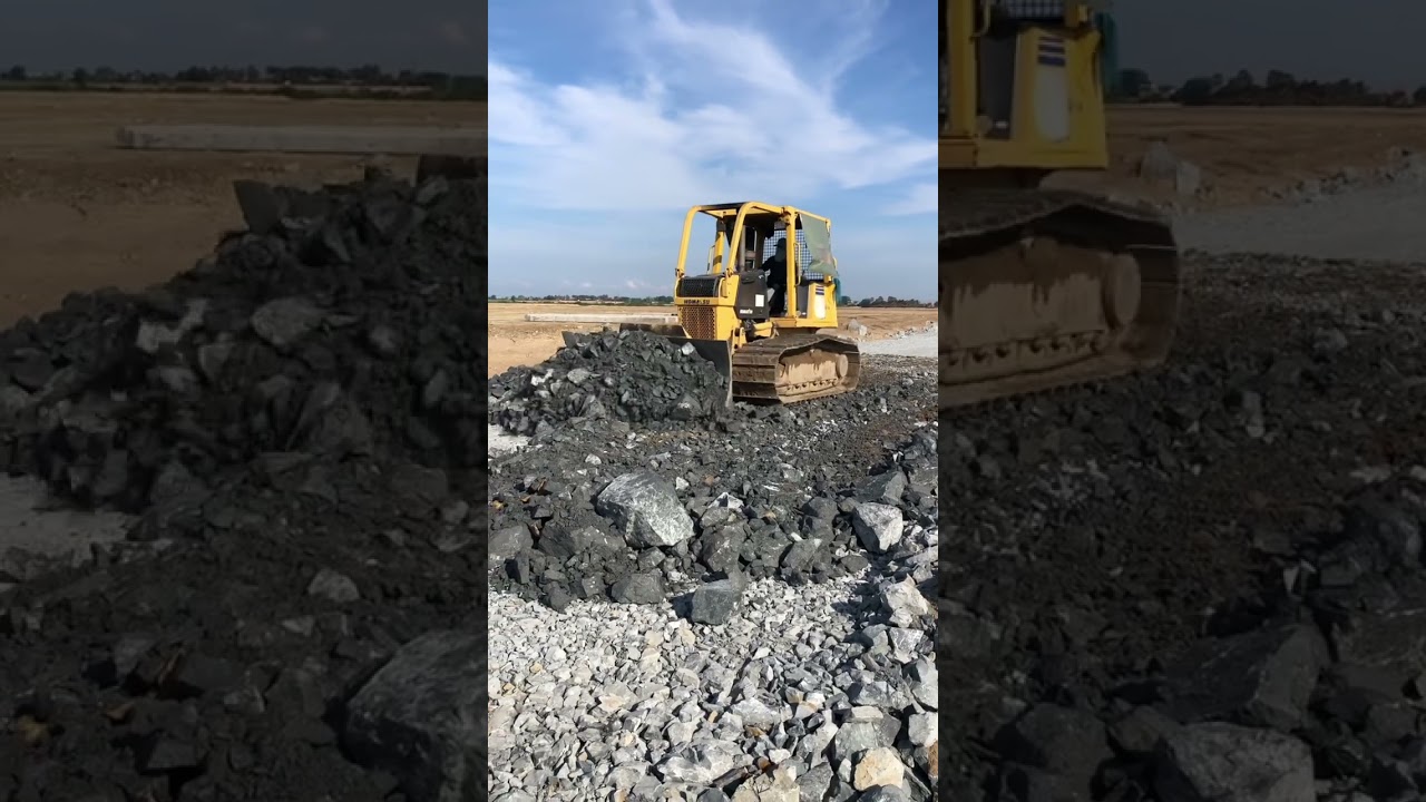 Komatsu bulldozers pushing rock for base road.