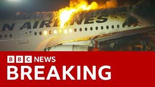 Japan Airlines plane in flames on the runway at Tokyo