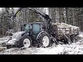 Valtra A124 forestry tractor logging in winter forest