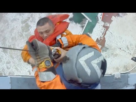 Dramatic moment sailor is airlifted from ship moments before it sinks in South China Sea