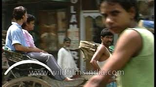 Traditional hand - pulled Indian rickshaw driver working on Kolkata's streets