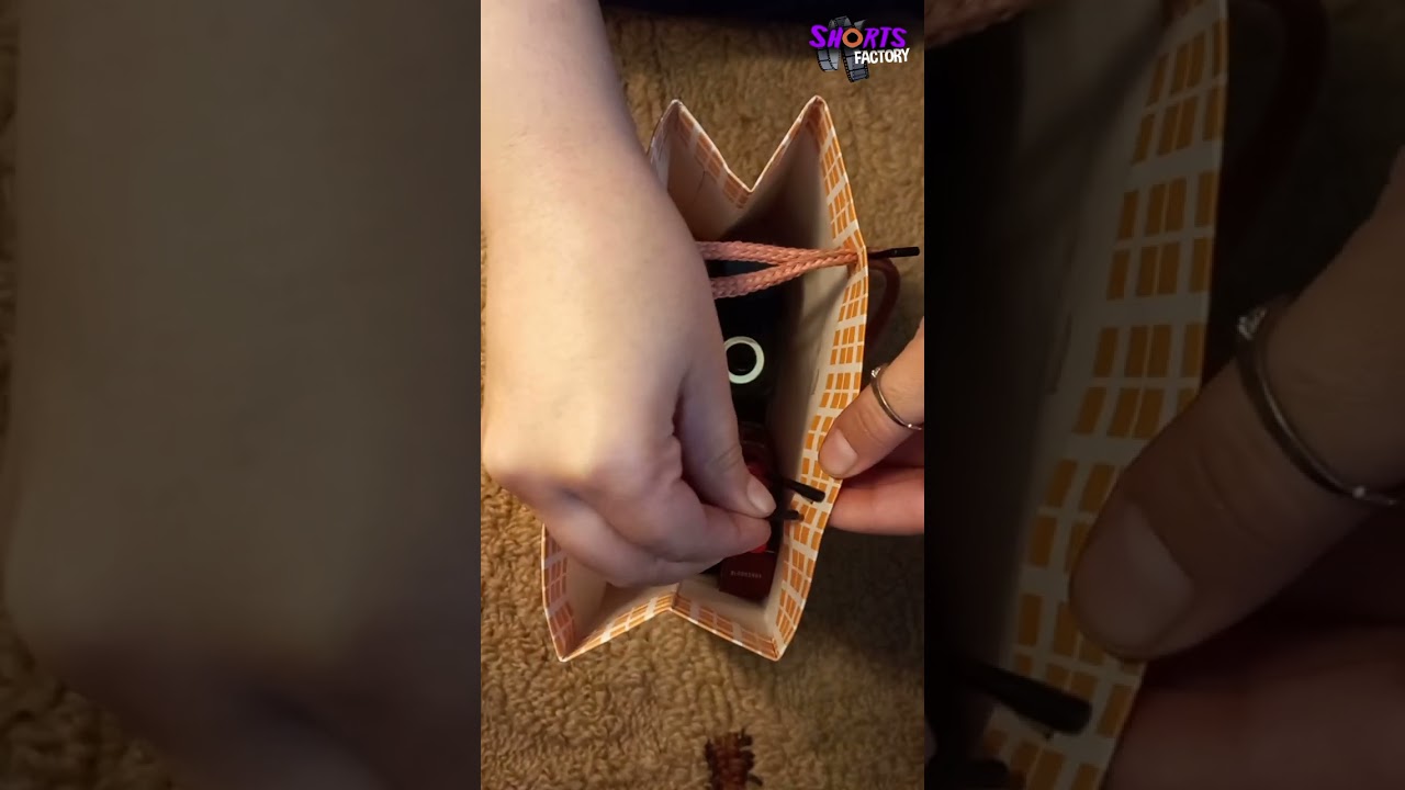 Closing a gift bag with its own string #bag  #hack #lifehacks #diygiftbag #shortsfeed #viralhacks